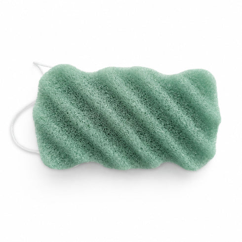 Sage green konjac body sponge with diagonal wavy ridges and a white hanging string on a white background.