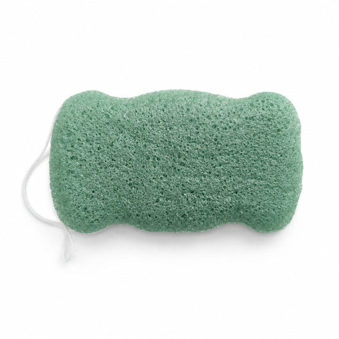 Flat, porous underside of a sage green konjac body sponge with a white hanging string on a white background.