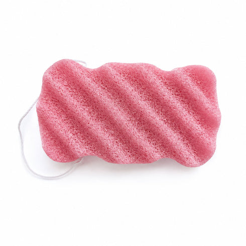 Dusty pink konjac body sponge with diagonal wavy ridges and a white hanging string on a white background.