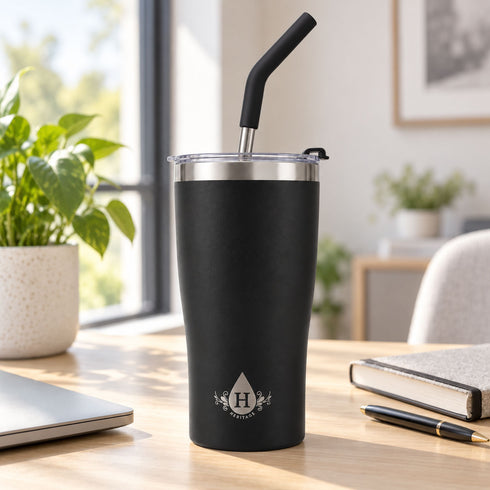 Matte black Heritage tumbler with straw on a desk