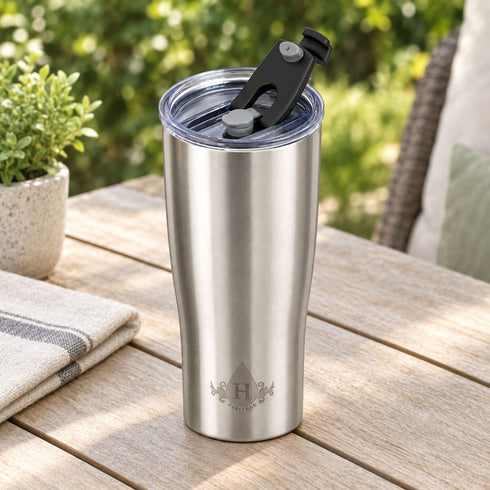 Brushed stainless steel Heritage tumbler with flip-back spout lid open on a patio table