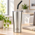 Brushed stainless steel Heritage tumbler with straw on a desk