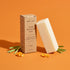eko + co. Vegan Stain Remover Bar kraft box and bar displayed with lemongrass, orange peel, and coconut for GreenWave wholesale catalogue