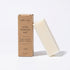 eko + co. Stain Remover Bar leaning against kraft box on white background — plastic-free solid bar format